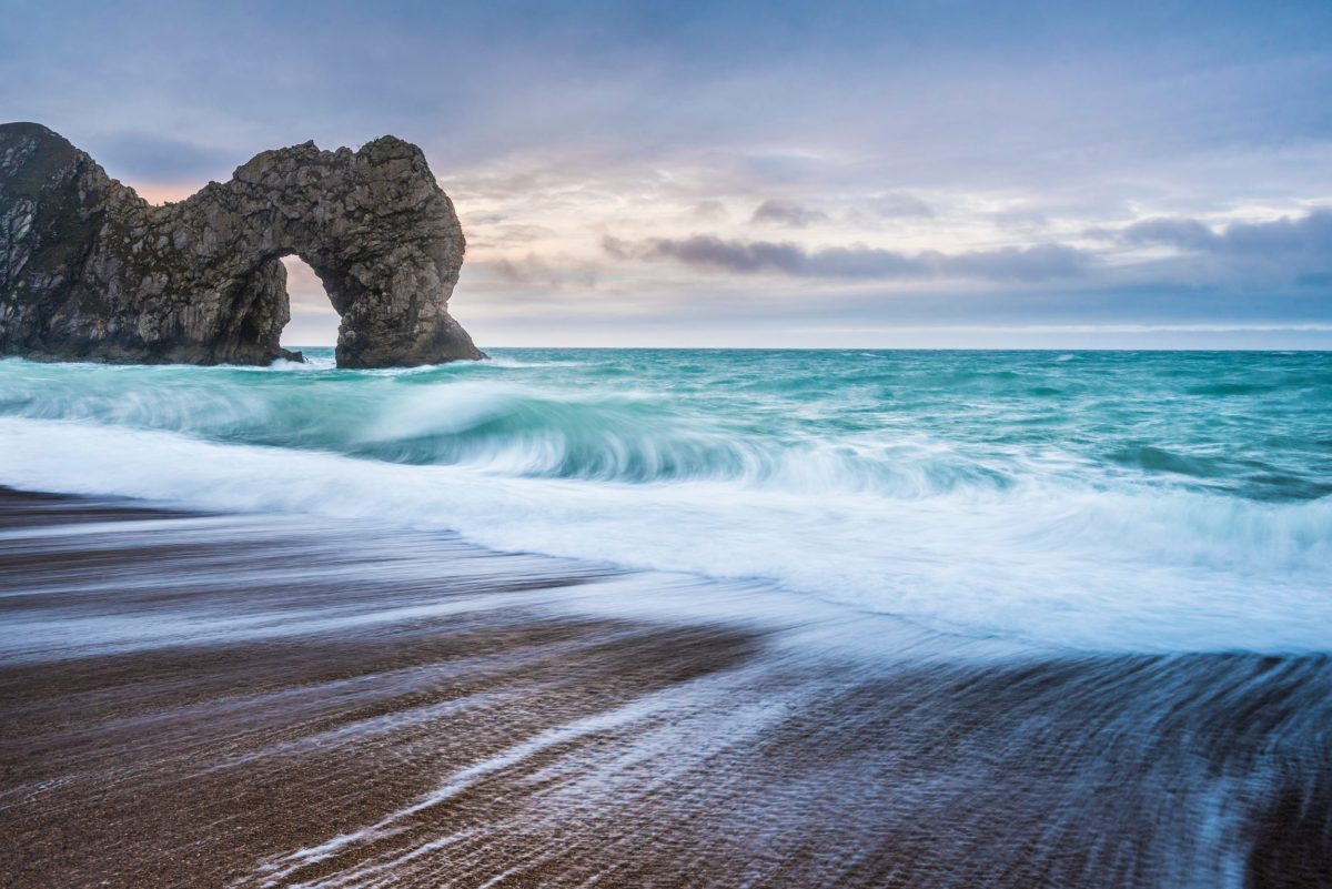 Durdle Door beach with clear blue sea on Dorset's Jurassic Coast near Silverlake Estate.