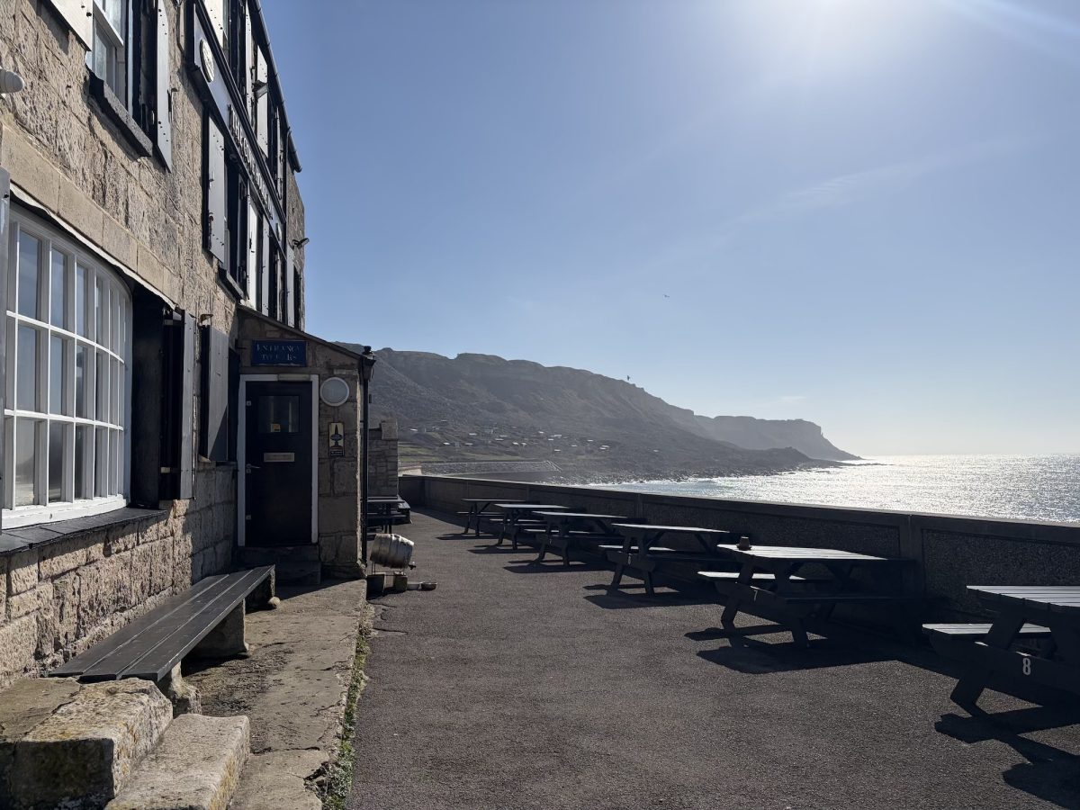 Outdoor seating at the Cove House Inn on Portland with views towards Chesil Beach in Dorset
