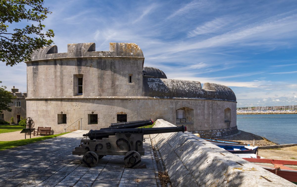 Portland Castle, Dorset, beneath a blue skies with historic guns pointing out to sea