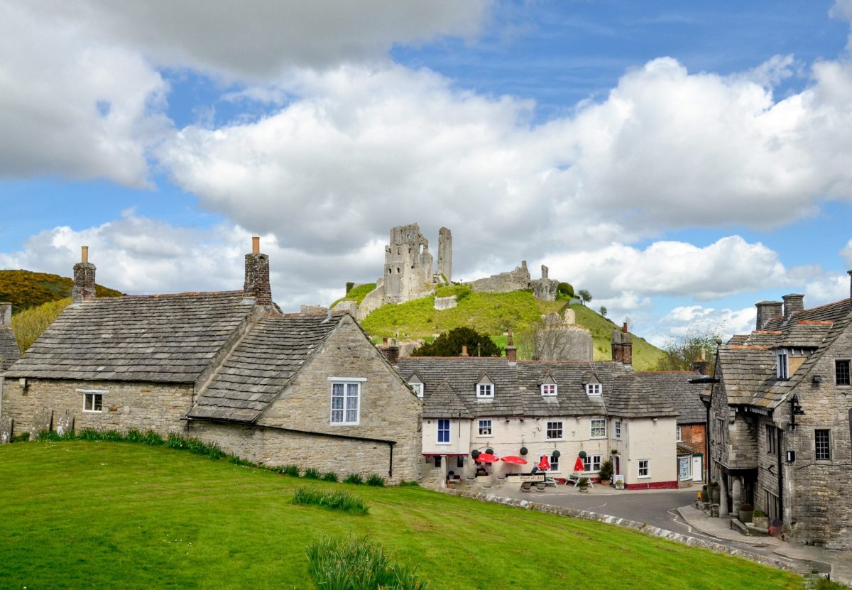 View of Corfe Castle overlooking the historic village and surrounding Purbeck countryside.