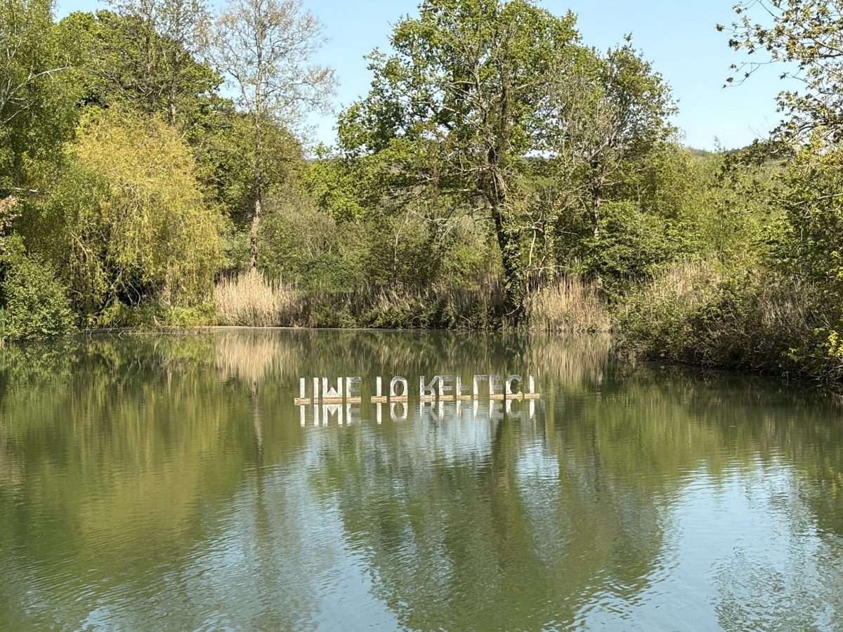 "Time to Reflect" sign reflection on the lake at Sculpture By The Lakes, near Dorchester, Dorset