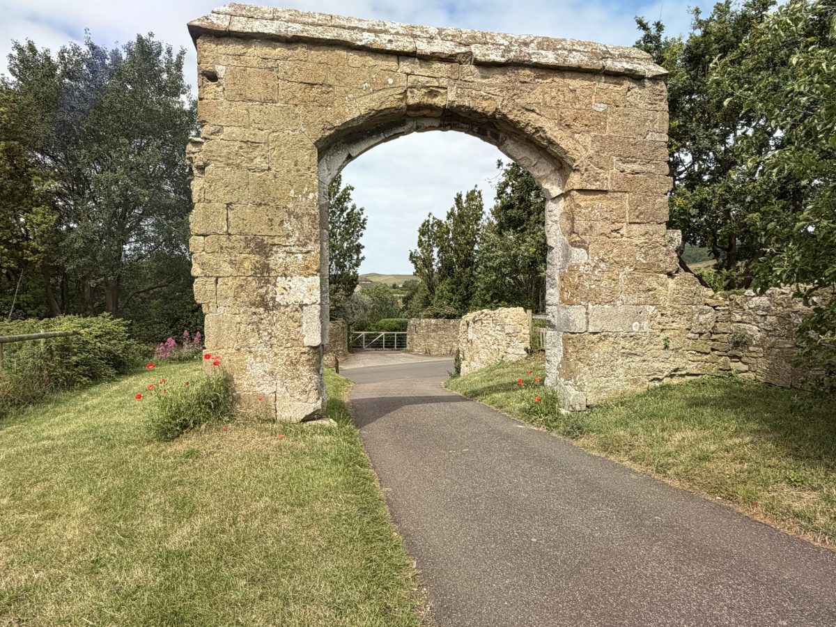 Medieval stone archway at the historic  Abbotsbury Abbey ruins in Dorset