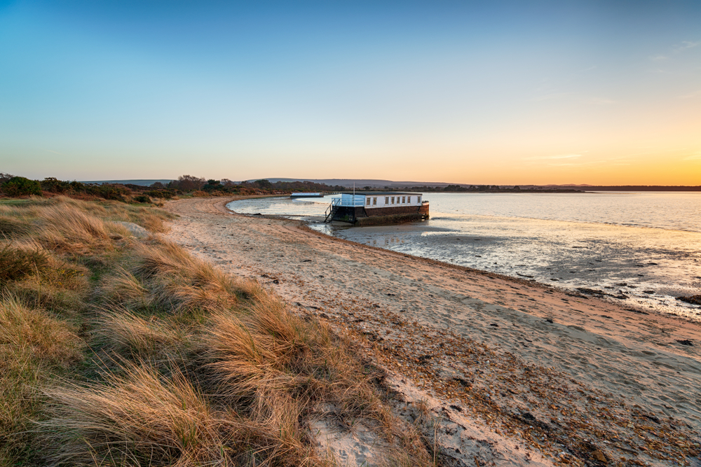 Sunset at Bramble Bush Bay, Studland in Dorset, a peaceful beach perfect for a luxury holiday