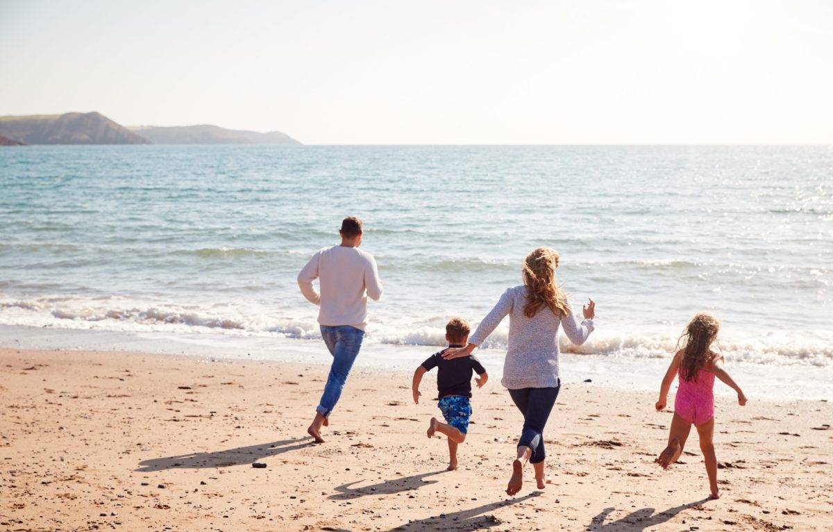 Family enjoying a last minute beach holiday on the Dorset coast