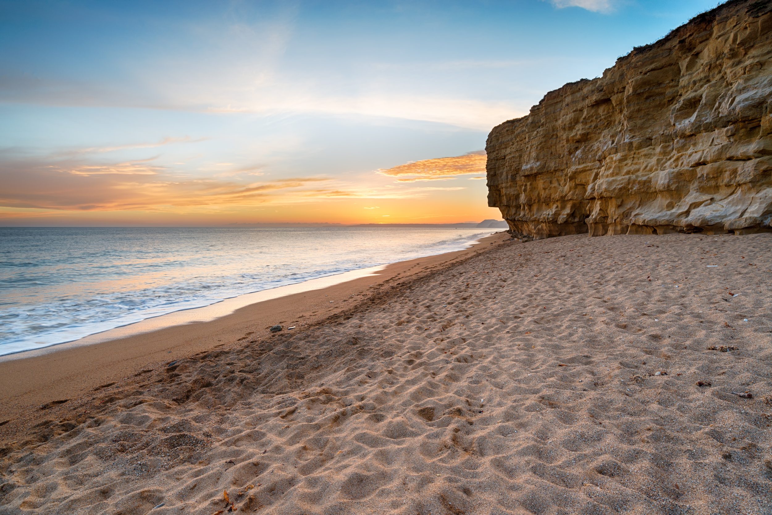 Golden sunset over Hive Beach in Burton Bradstock on Dorset's Jurassic Coast