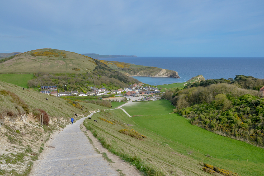 Walking towards Lulworth Cove on Dorset's Jurassic Coast during a relaxing holiday