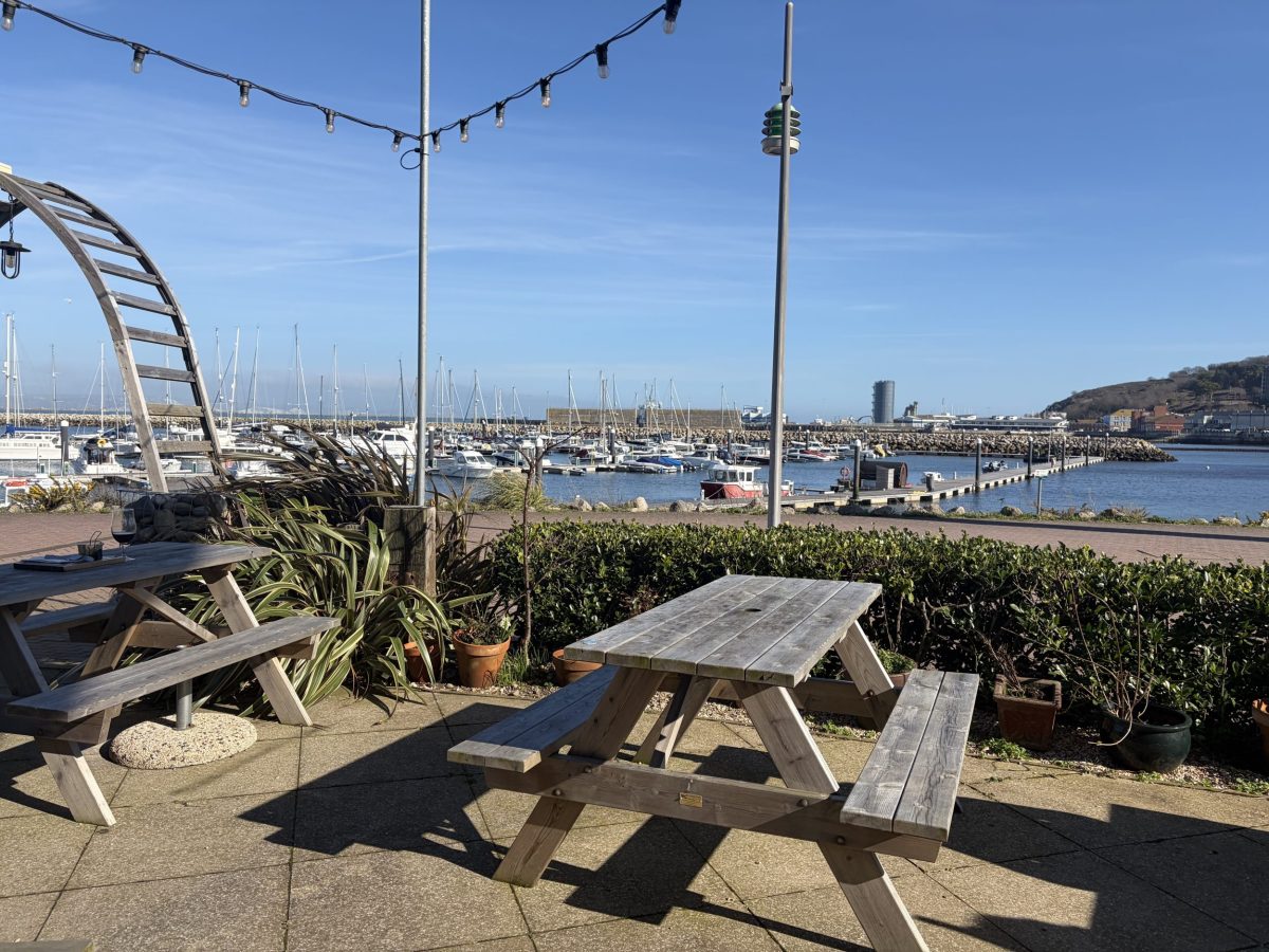 Outdoor dining terrace at Salt restaurant overlooking Portland Marina in Dorset