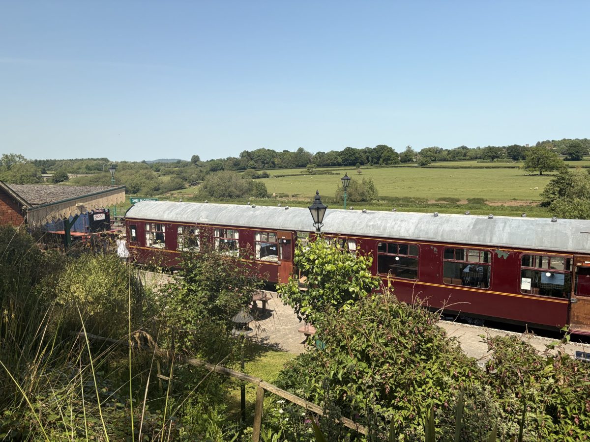 Historic railway carriages at Shillingstone Railway station surrounded by Dorset countryside