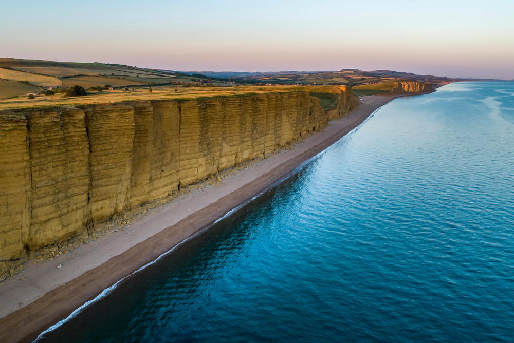 Golden cliffs at West Bay in Dorset, one of the county's most spectacular places to visit during a luxury holiday