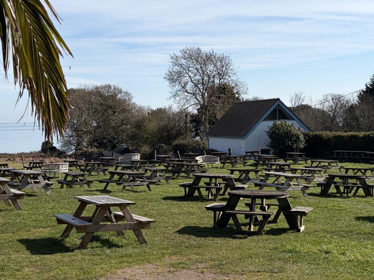 Beer garden at The Bankes Arms in Studland overlooking the Dorset coastline.