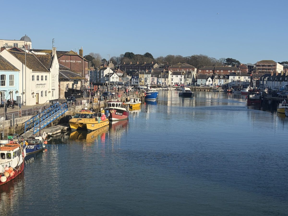 View across Weymouth Harbour on a sunny day, one of the best places to eat in Dorset with waterfront restaurants and cafés.