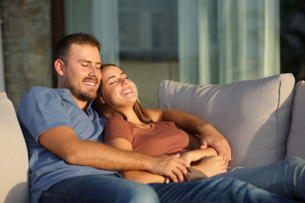 Couple relaxing outside a luxury holiday cottage at Silverlake Estate in Dorset.