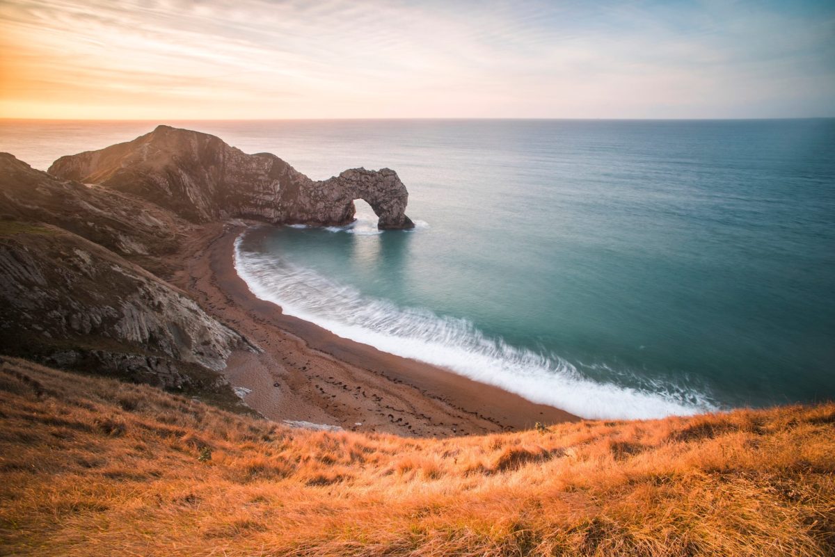 Aerial view of Durdle Door at sunrise on Dorset's Jurassic Coast, Britain's most filmed coastal region.