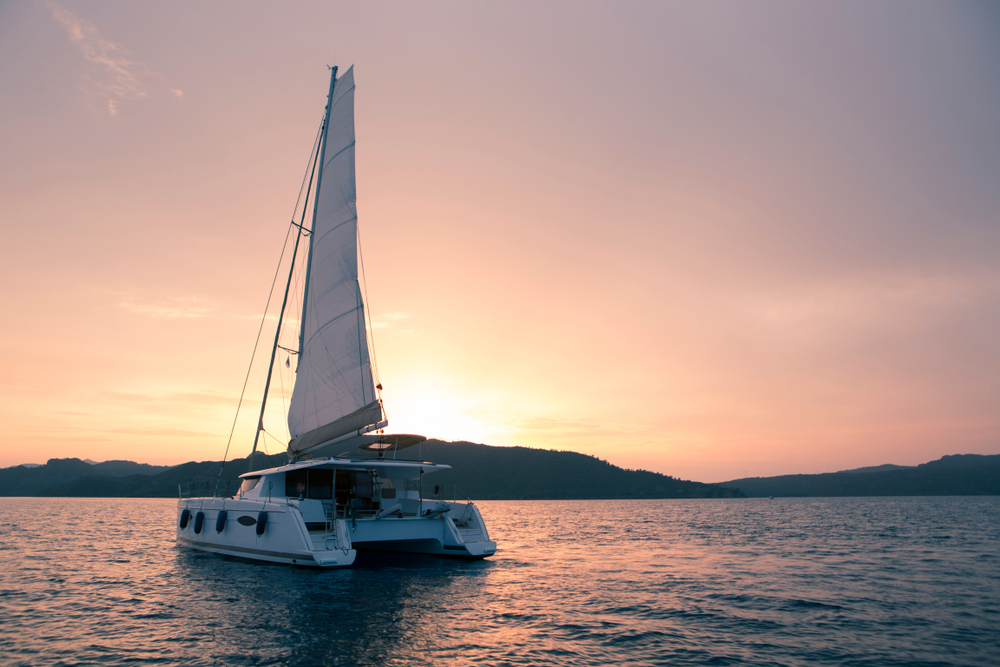 Private sailing charter cruising past Durdle Door on Dorset's Jurassic Coast