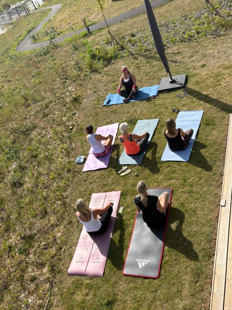 Private outdoor yoga session beside a luxury cottage at Silverlake Estate in Dorset.