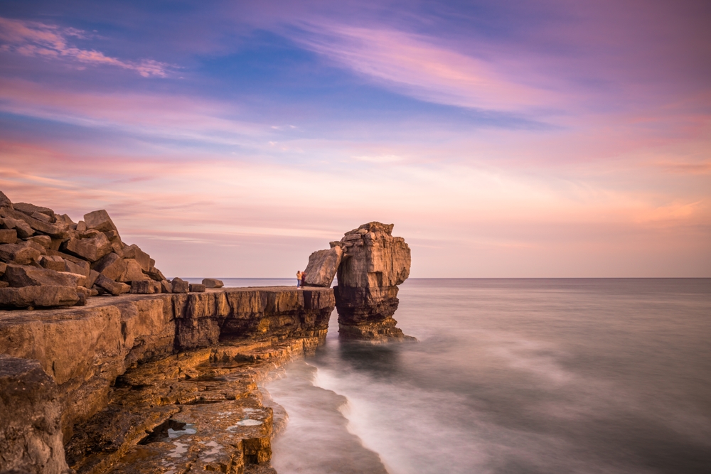 Pulpit Rock on the Isle of Portland with dramatic clouds above the Dorset coastline.