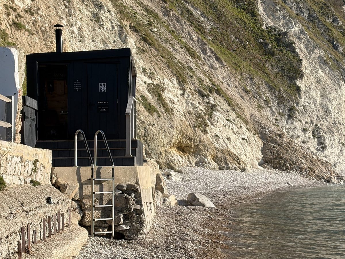 The Saltwater Sauna on Lulworth Cove beach overlooking the Jurassic Coast in Dorset