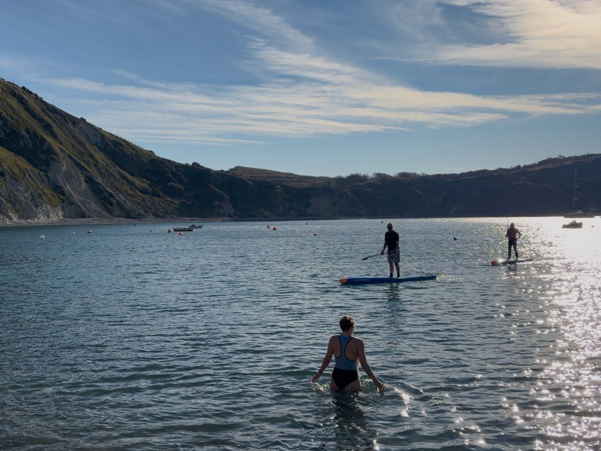 Person swimming in Lulworth Cove after a Saltwater Sauna session on Dorset's Jurassic Coast