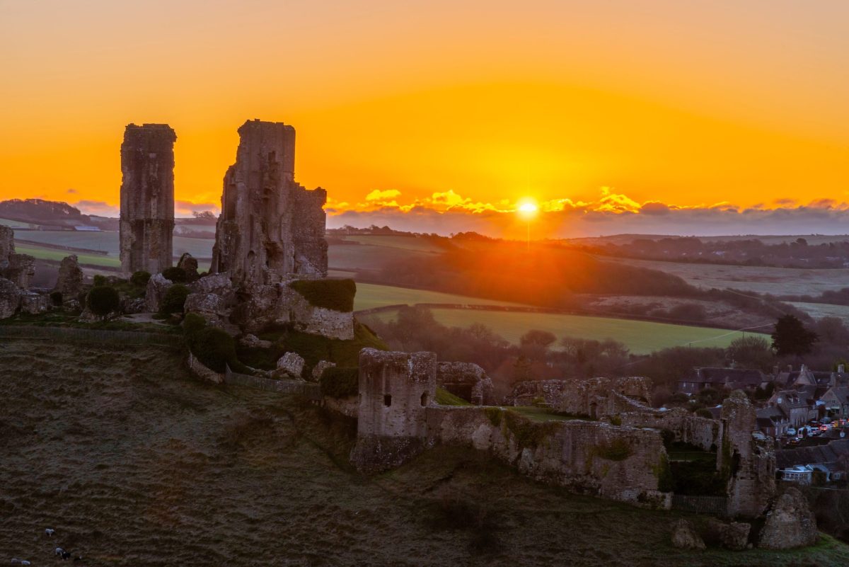 Sunrise over Corfe Castle and the surrounding Purbeck countryside in Dorset