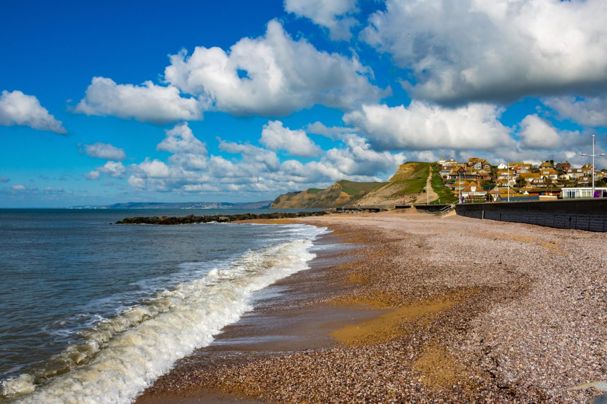 East Beach at West Bay with views towards the harbour, town and surrounding Jurassic Coast cliffs.