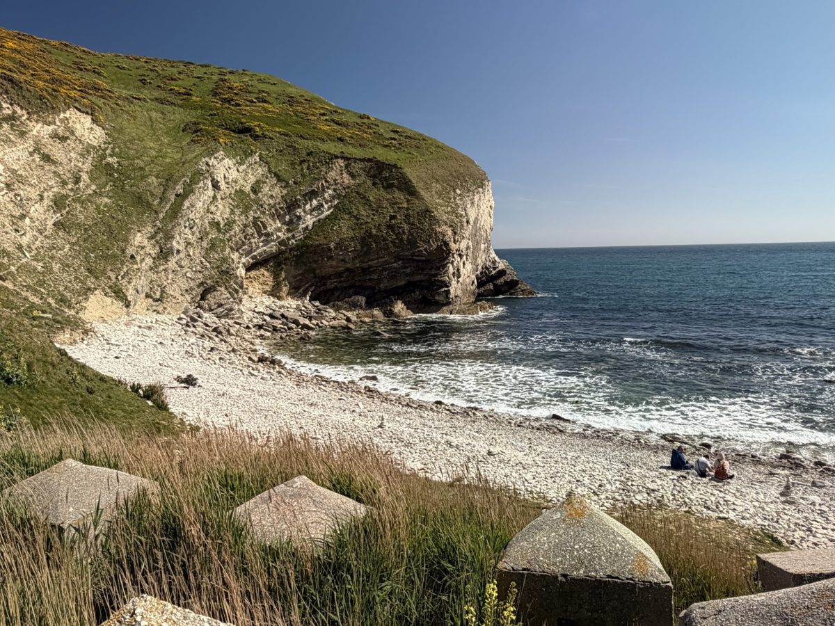 The empty beach at Ponfield Cove, near Worbarrow Bay, Dorset, beneath blue skies