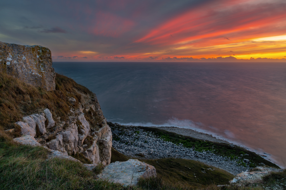 Sunset over Portland's rugged cliffs on Dorset's Jurassic Coast.