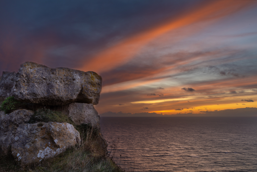 Portland Stone cliffs overlooking the sea at sunrise on Dorset's Jurassic Coast.