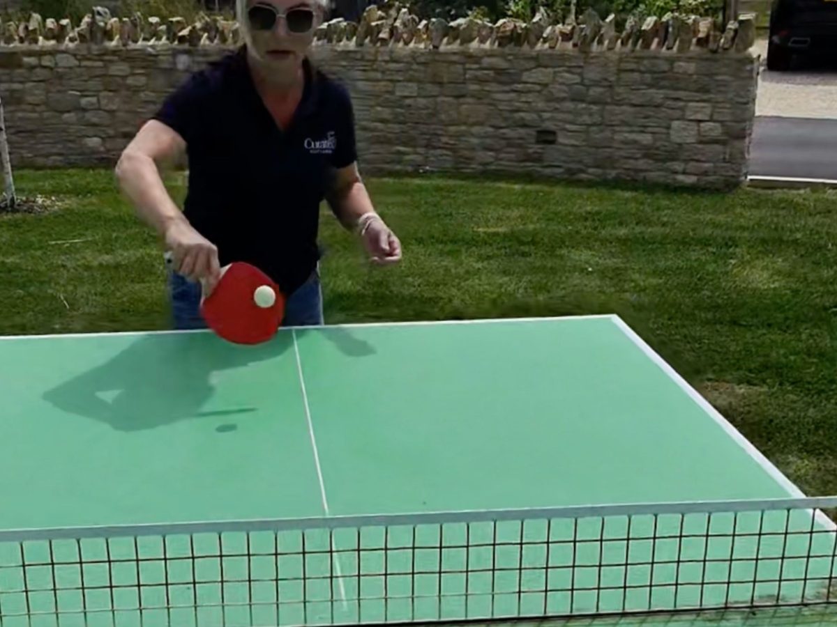 Shona, Co-Founder of Curated Cottages, playing table tennis at Silverlake Estate, Dorset
