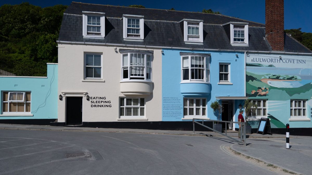 Entrance to the Lulworth Cove Inn with its distinctive blue-painted exterior in Dorset.