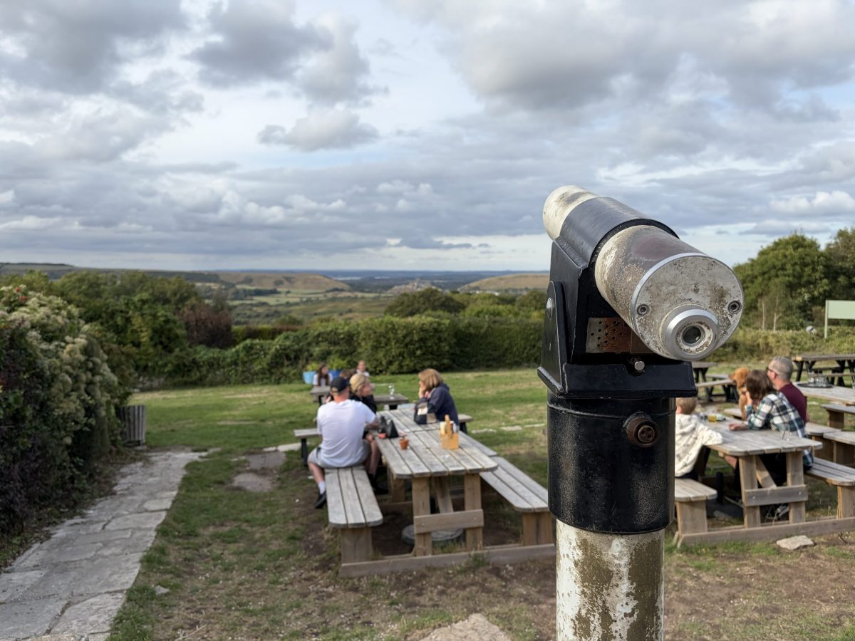 Telescope in the beer garden at The Scott Arms in Kingston overlooking Corfe Castle and the Purbeck countryside
