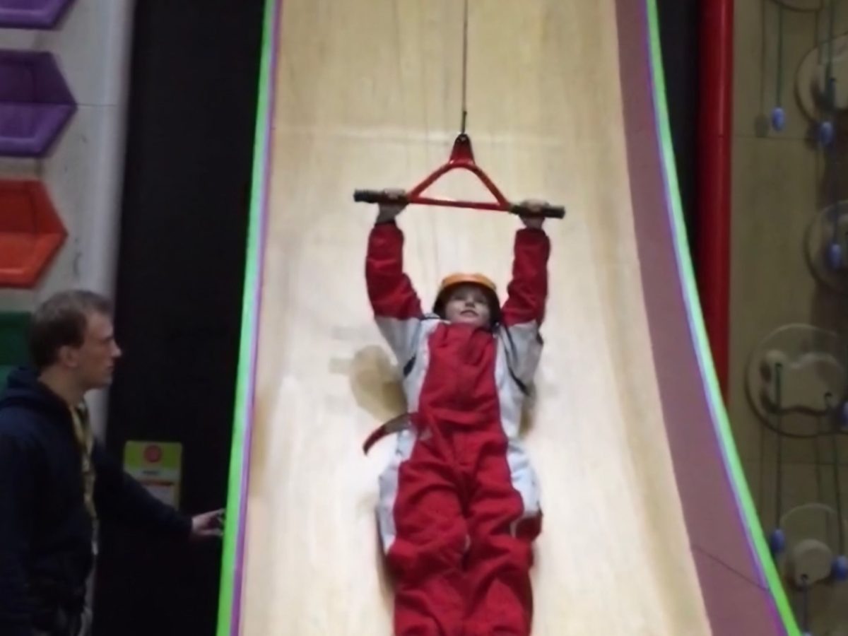 Young boy being pulled upwards on the Vertical Drop Slide at RockReef on Bournemouth Pier.
